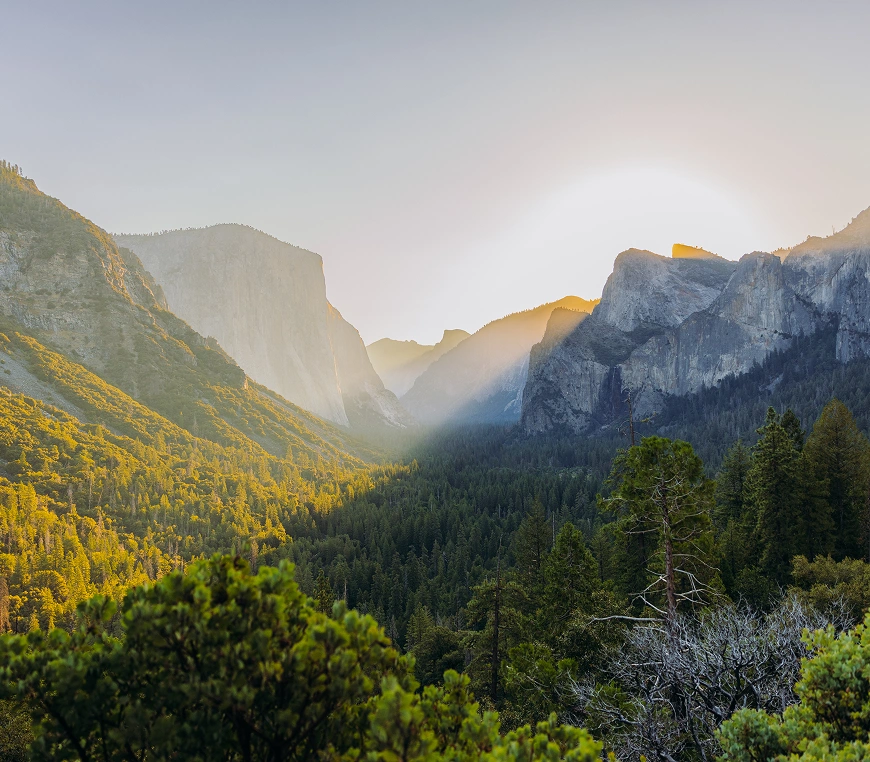 Sunrise over mountains and forest landscape.