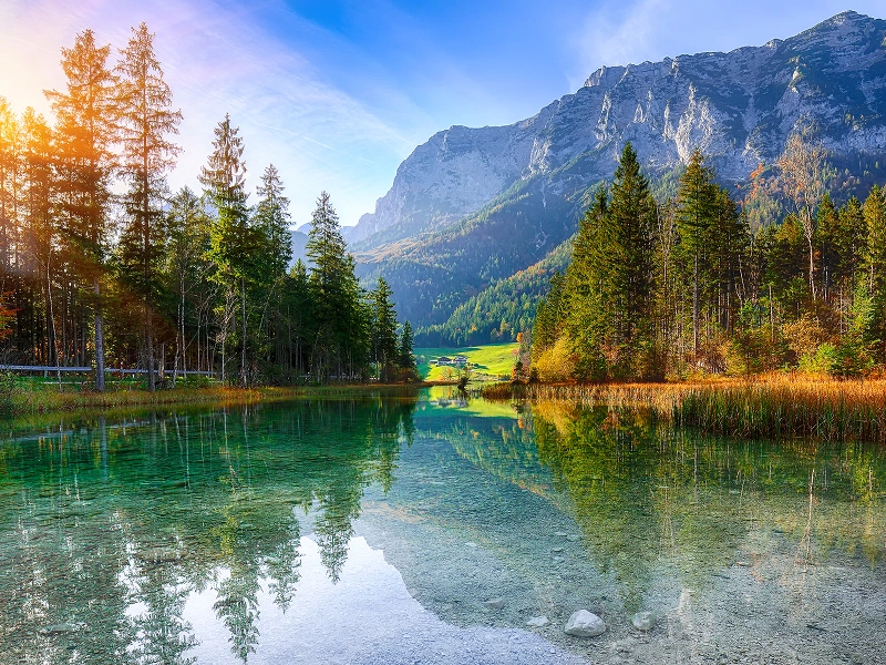Mountain lake with trees and clear reflection.